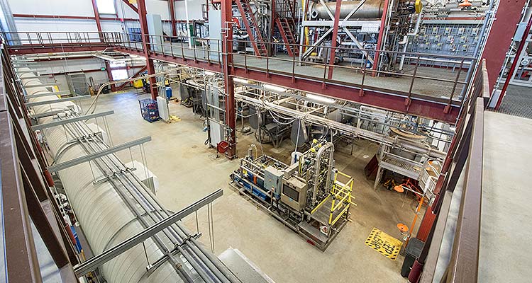 33953 Photo of a large, industrial space with two floors of testing equipment.