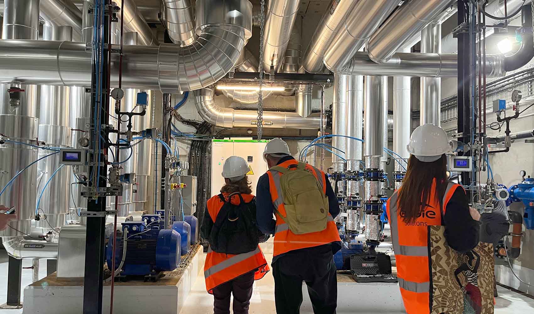 heating-cooling-and-storage-technologies workers in orange vests surrounded by heat pumps