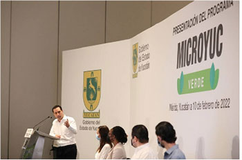 mvfi-presenter Yucatán Governor, Mauricio Villa speaks at podium in front of panel