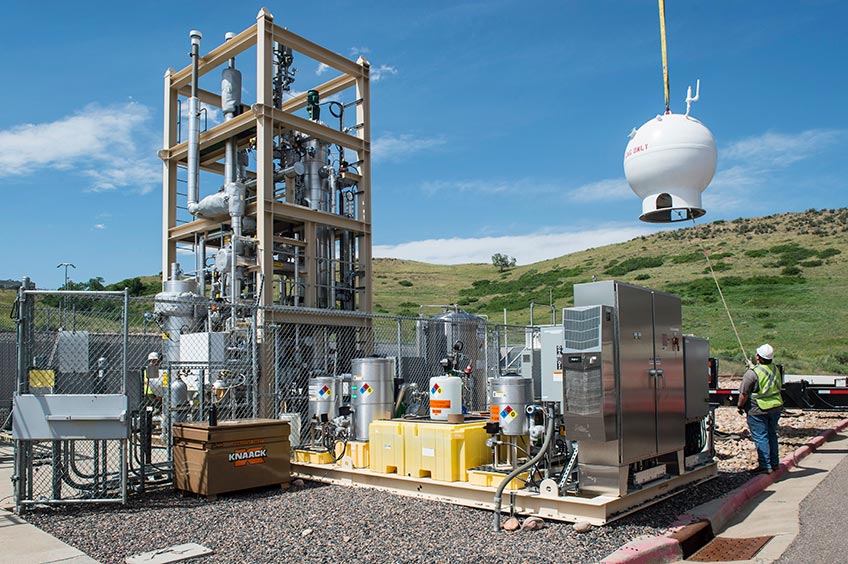amo-57497 Crews crane a natural gas storage vessel into place in a bioreactor.