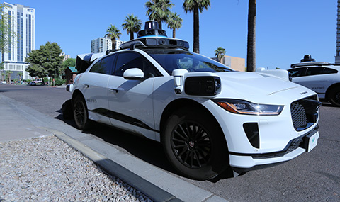 A white Waymo autonomous