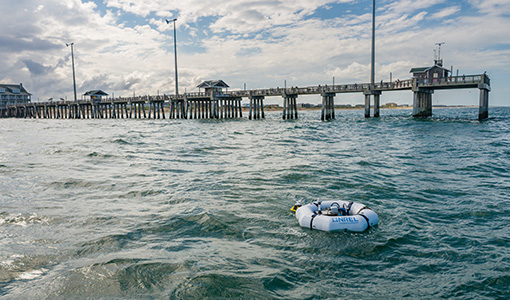 Continue reading about A device floats in front of a pier.