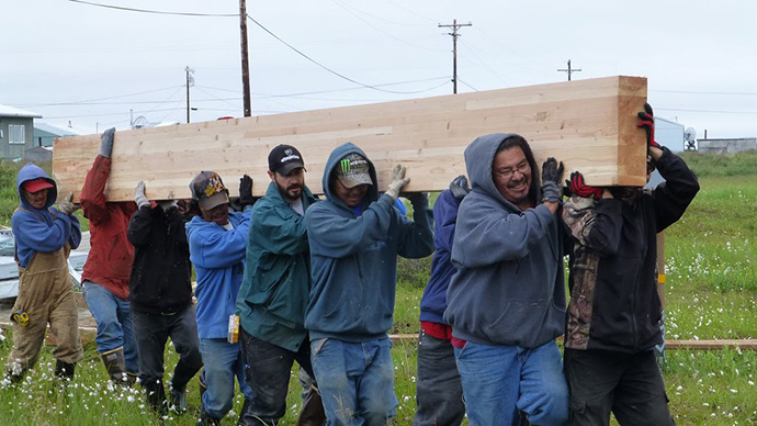 decision-support-ftr-64251 A group of people carrying a large peice of lumber.